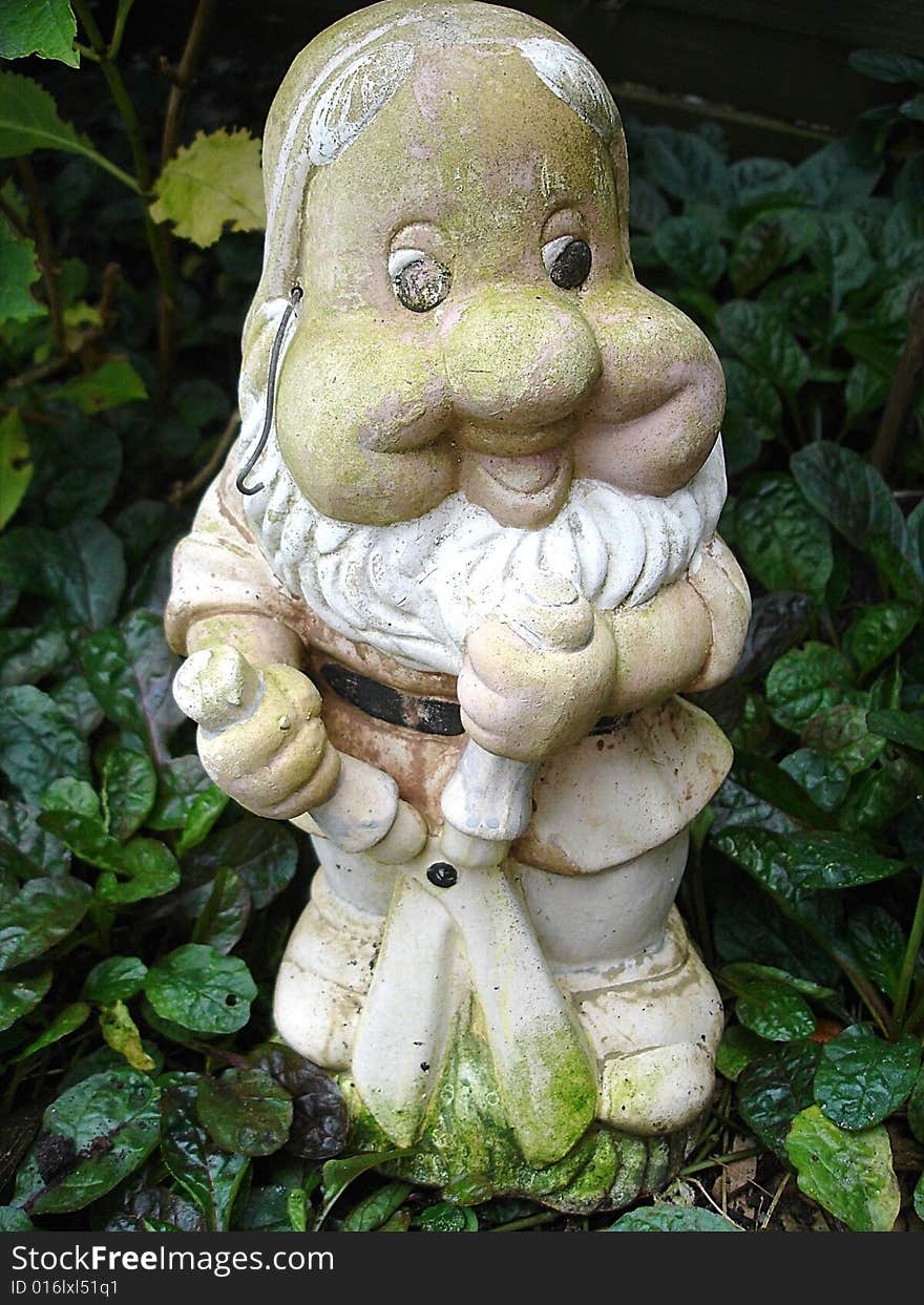 A very old weathered garden gnome