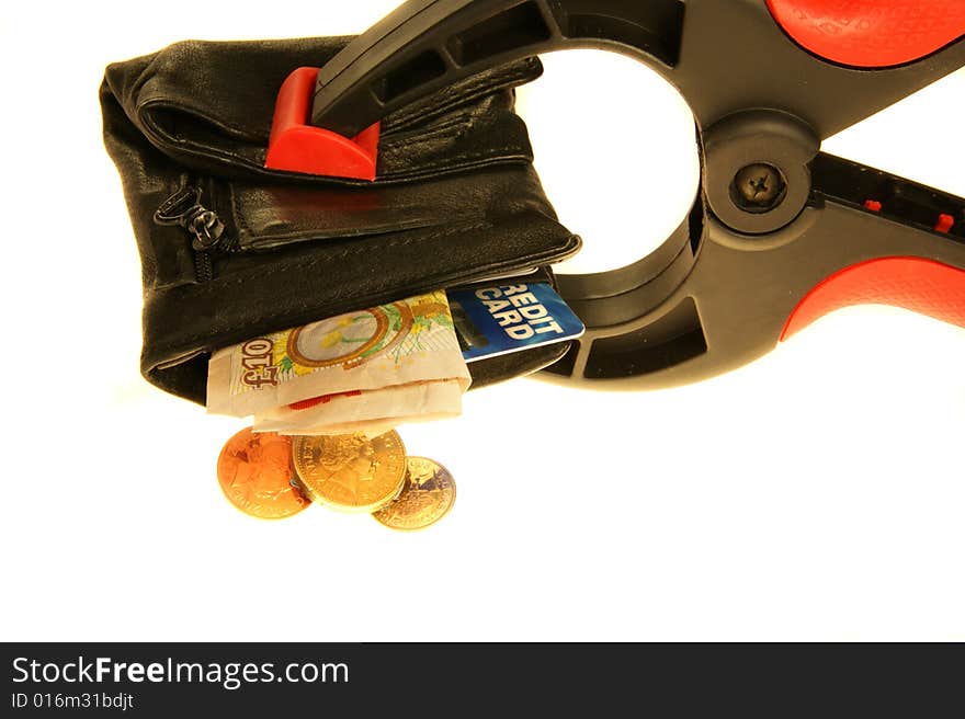 Wallet held in a clamp with credit card and british pound coins/notes. Wallet held in a clamp with credit card and british pound coins/notes