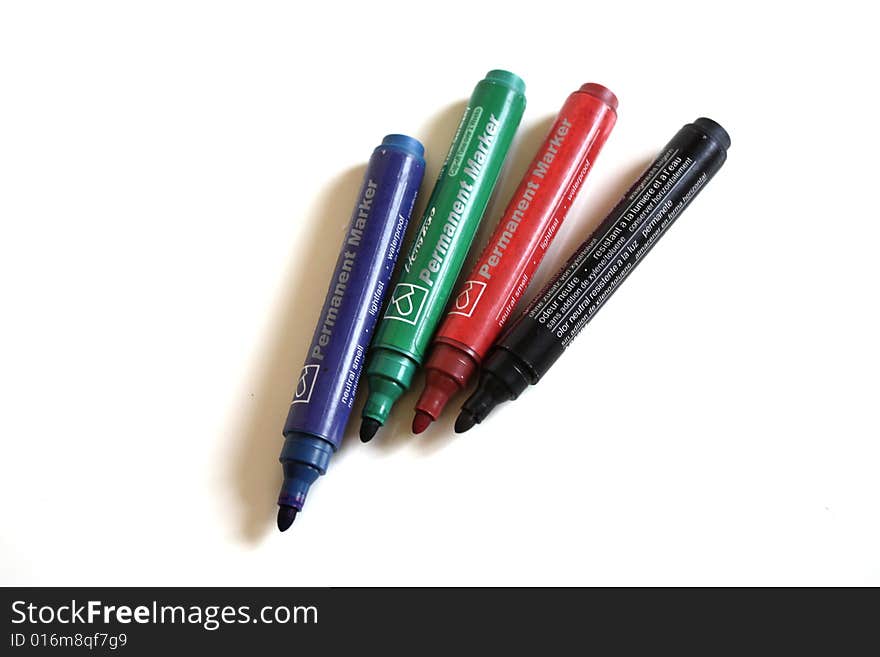 Office pens with different colors on white background