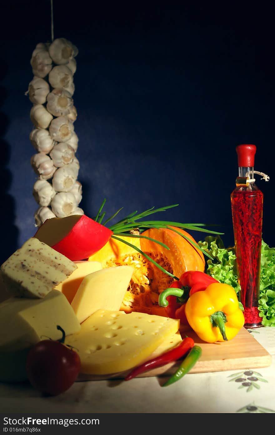 Still-life with cheese, oil with spice and vegetables from an autumn crop. Still-life with cheese, oil with spice and vegetables from an autumn crop.