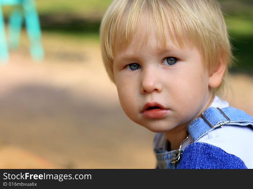 Portrait of the serious child with light hair and beautiful eyes