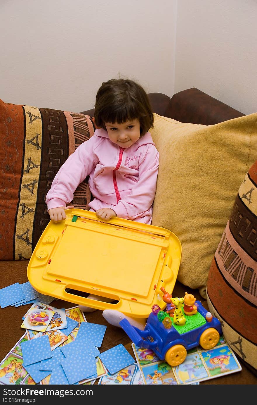 Child sitting on the couch and playing. Child sitting on the couch and playing