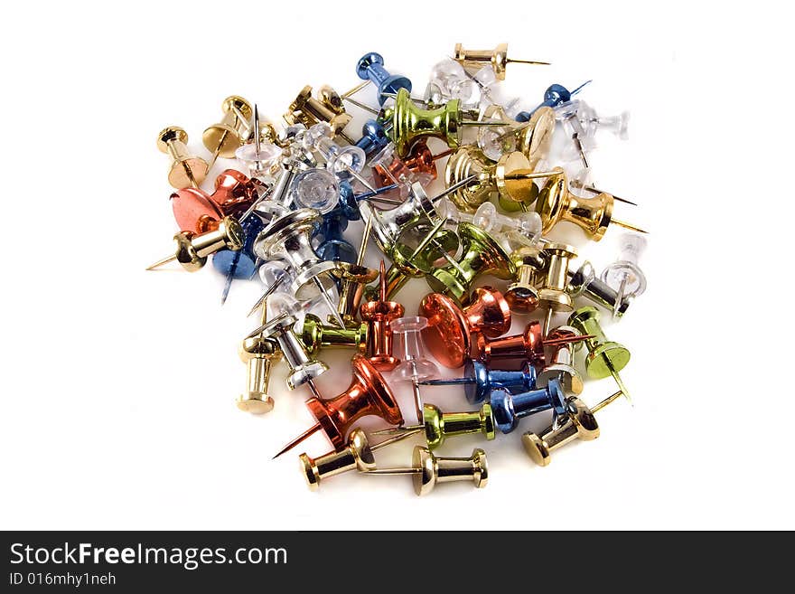 Colorful metallic push pins in a pile on a white background. Colorful metallic push pins in a pile on a white background.