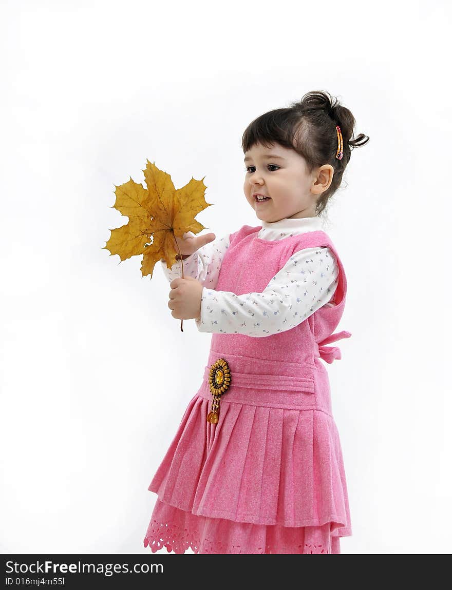 The little girl is holding in his hand upavshy leaf from a tree