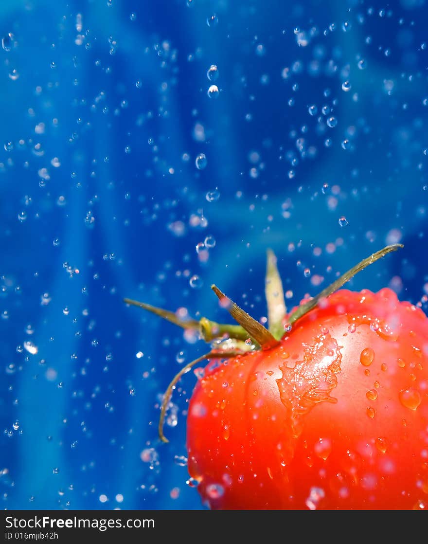 Tomato dropping ina splash of water drops. Tomato dropping ina splash of water drops