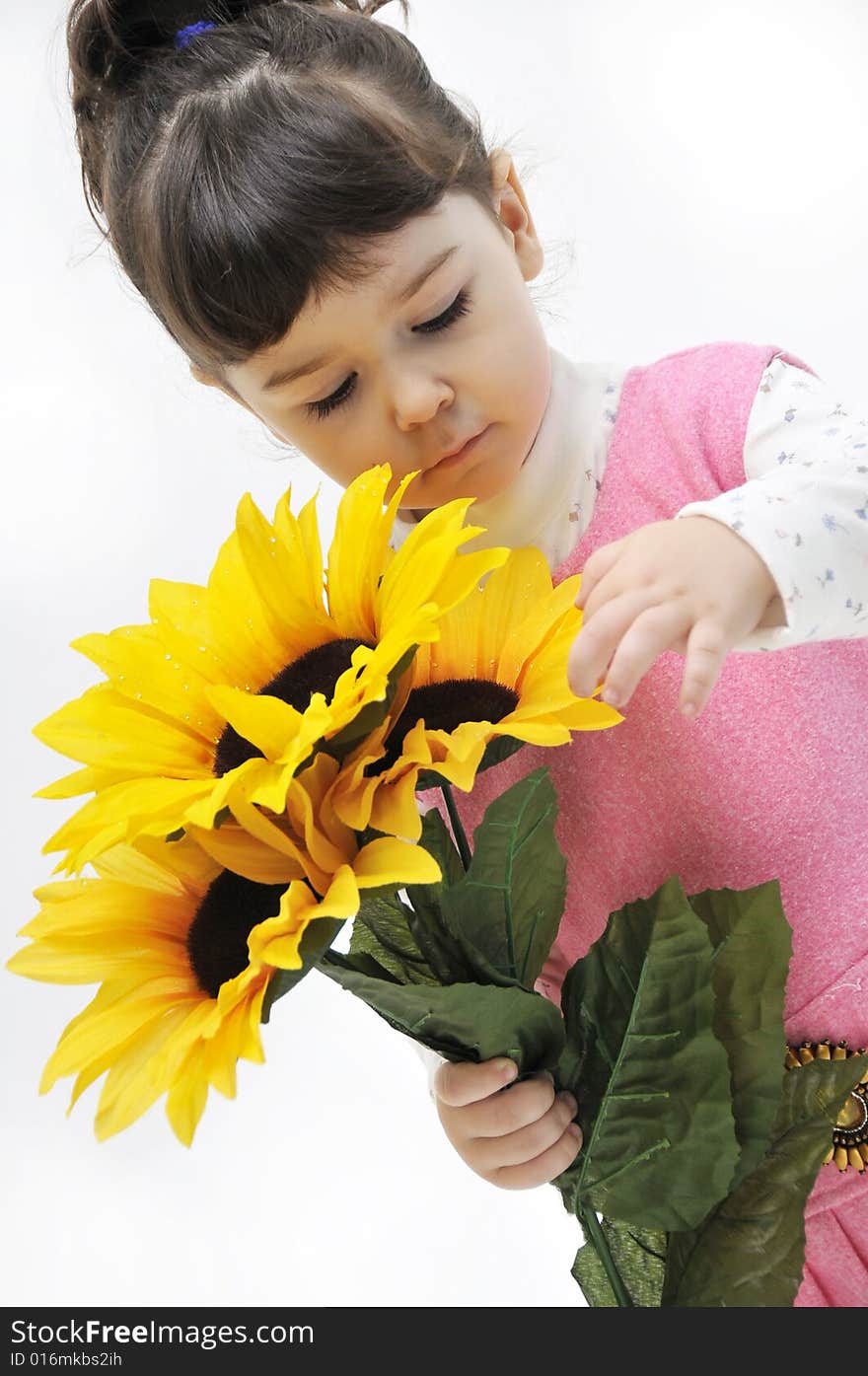 The little girl in pink dress with flowers