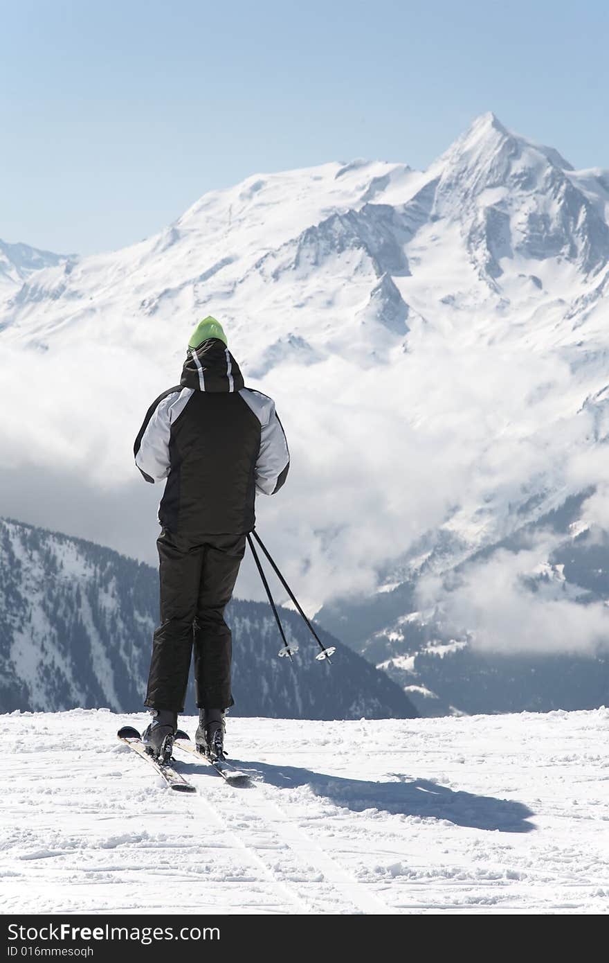 Skier takes a break; in background the french alps, Europe.