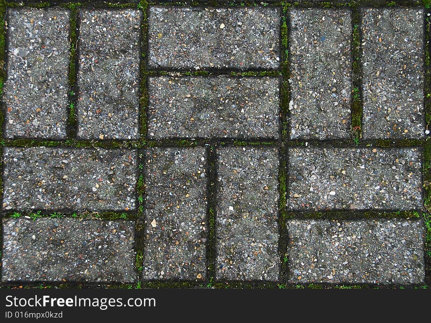 A patterned walkway with moss growing in between the bricks. Can be tiled up seamlessly to make a larger graphic background. A patterned walkway with moss growing in between the bricks. Can be tiled up seamlessly to make a larger graphic background.