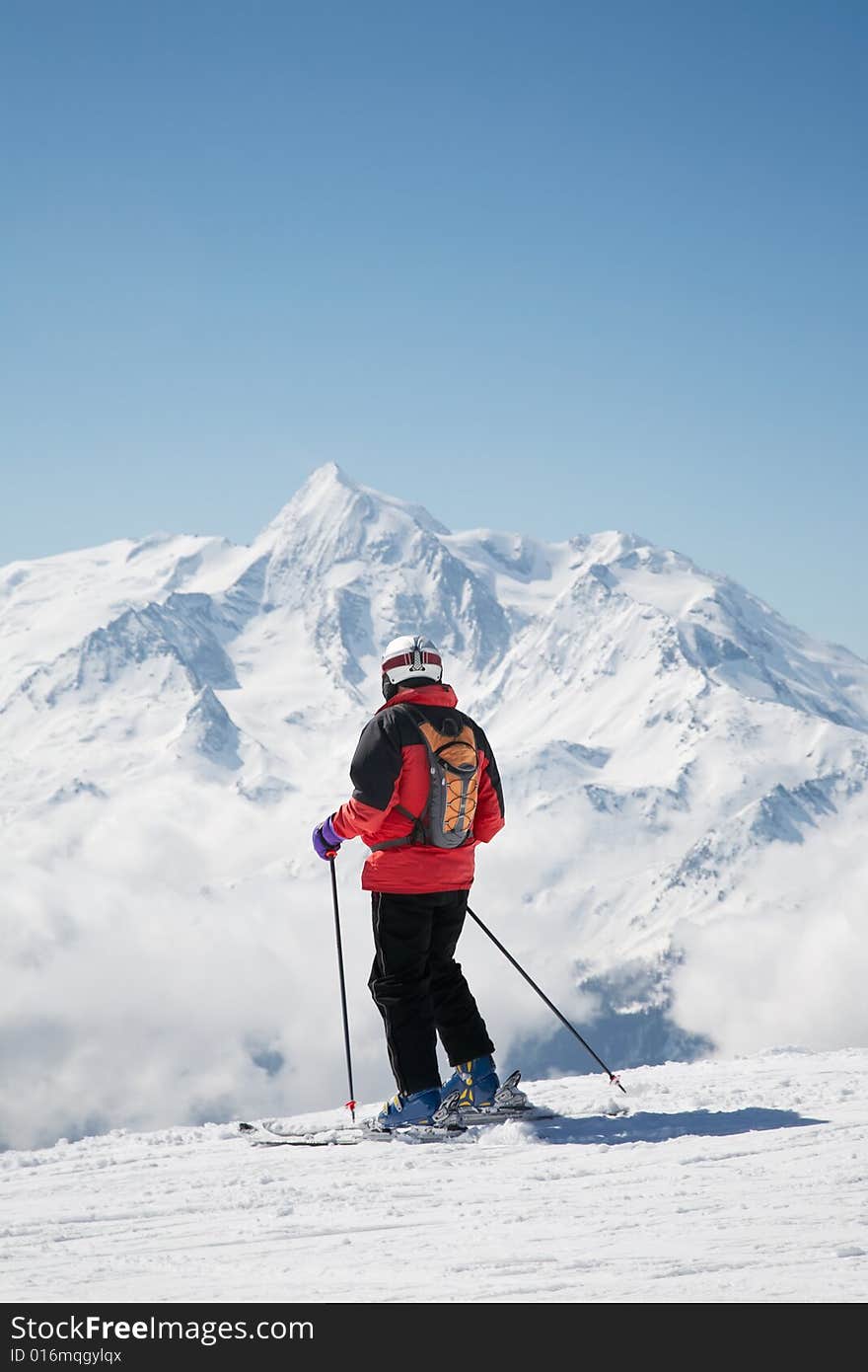 Skier takes a break; in background the french alps, Europe.