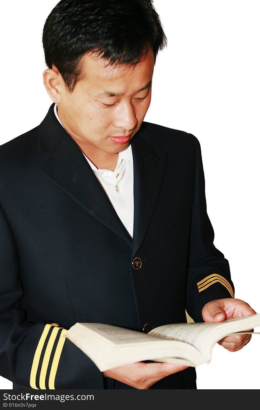 A young man reading a book   at home.