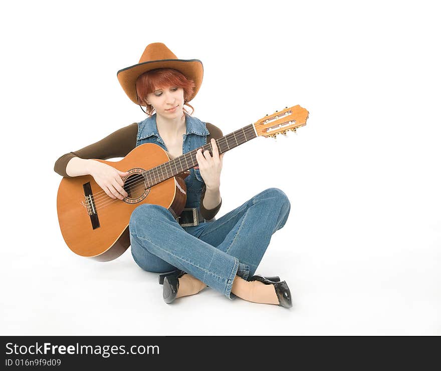 Woman sitting on a floor and playing guitar. Woman sitting on a floor and playing guitar