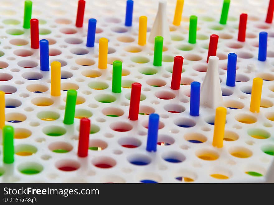 Colourful mosaic pins nailed into board