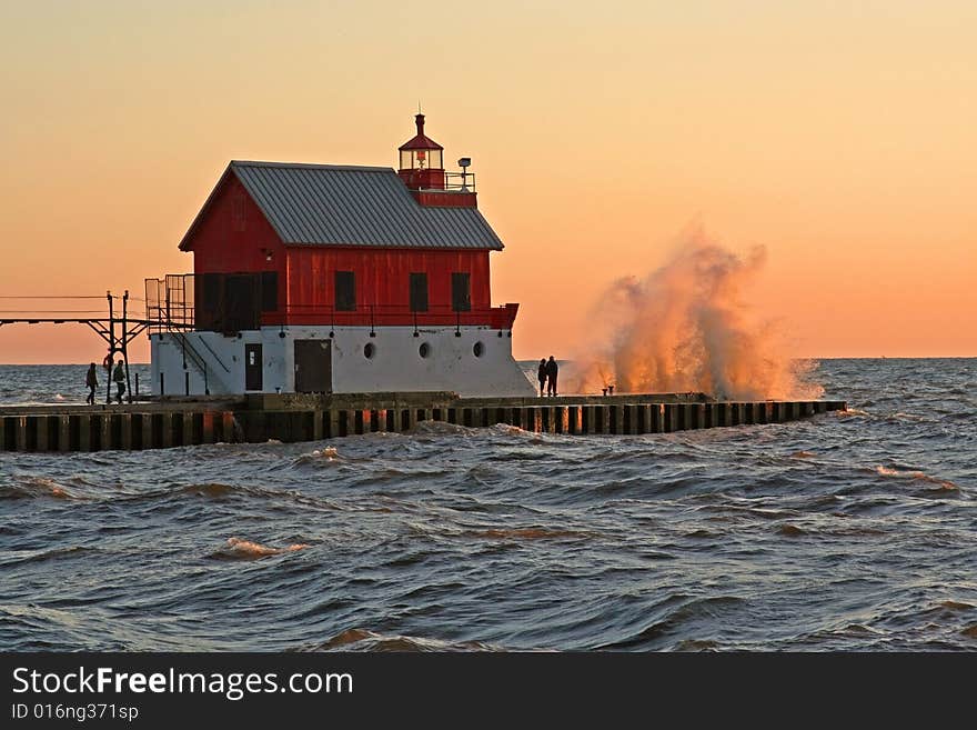 A large wave breaking over the south pier lighthouse at Grand Haven, MI. A large wave breaking over the south pier lighthouse at Grand Haven, MI