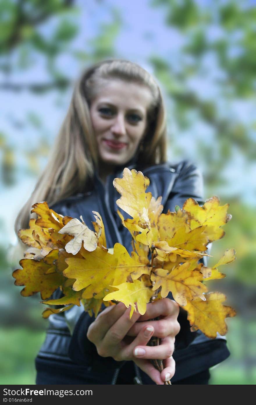 The beautiful girl presents the autumn bouquet. The beautiful girl presents the autumn bouquet