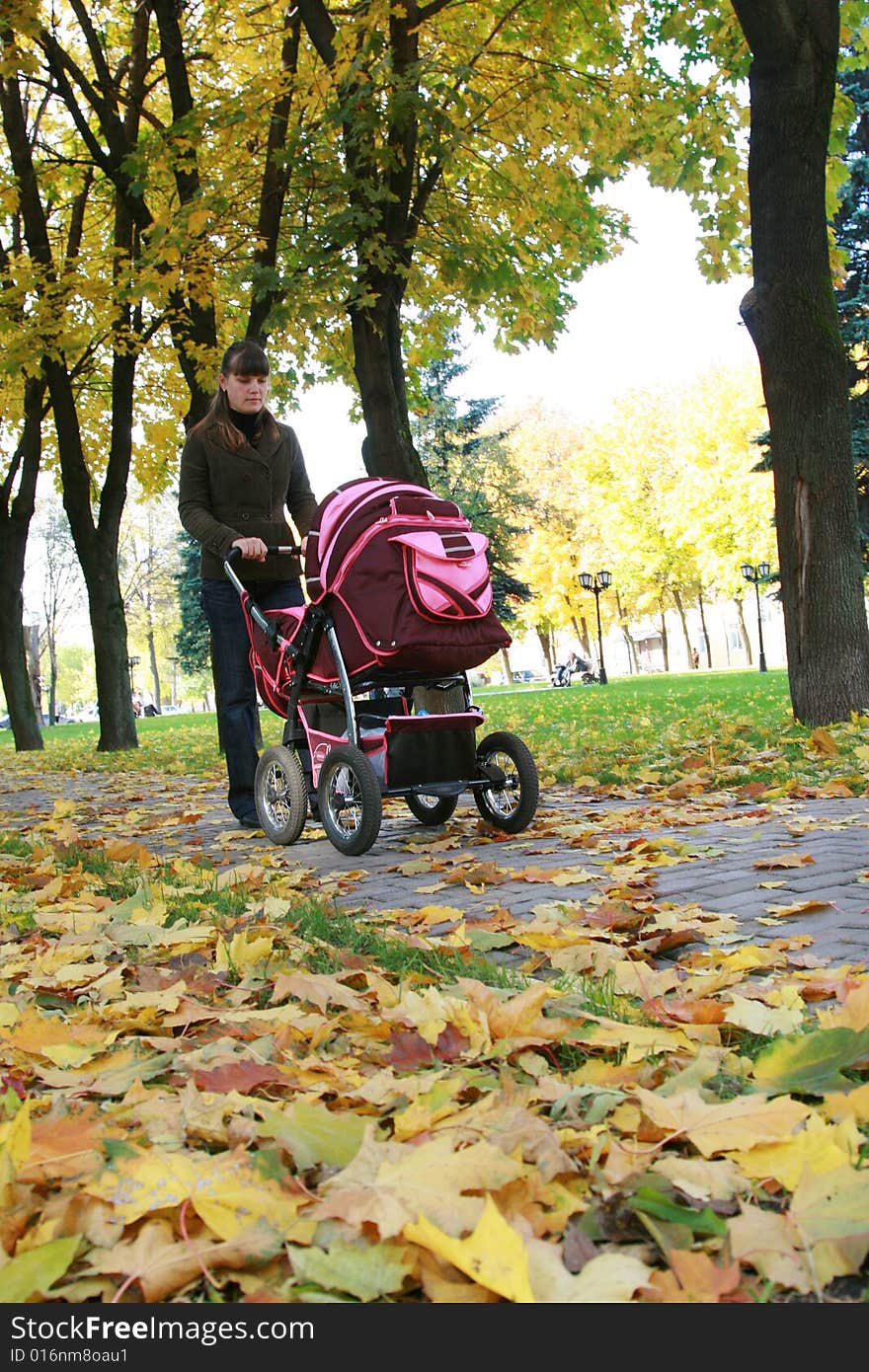 Young mother walks in park with the child