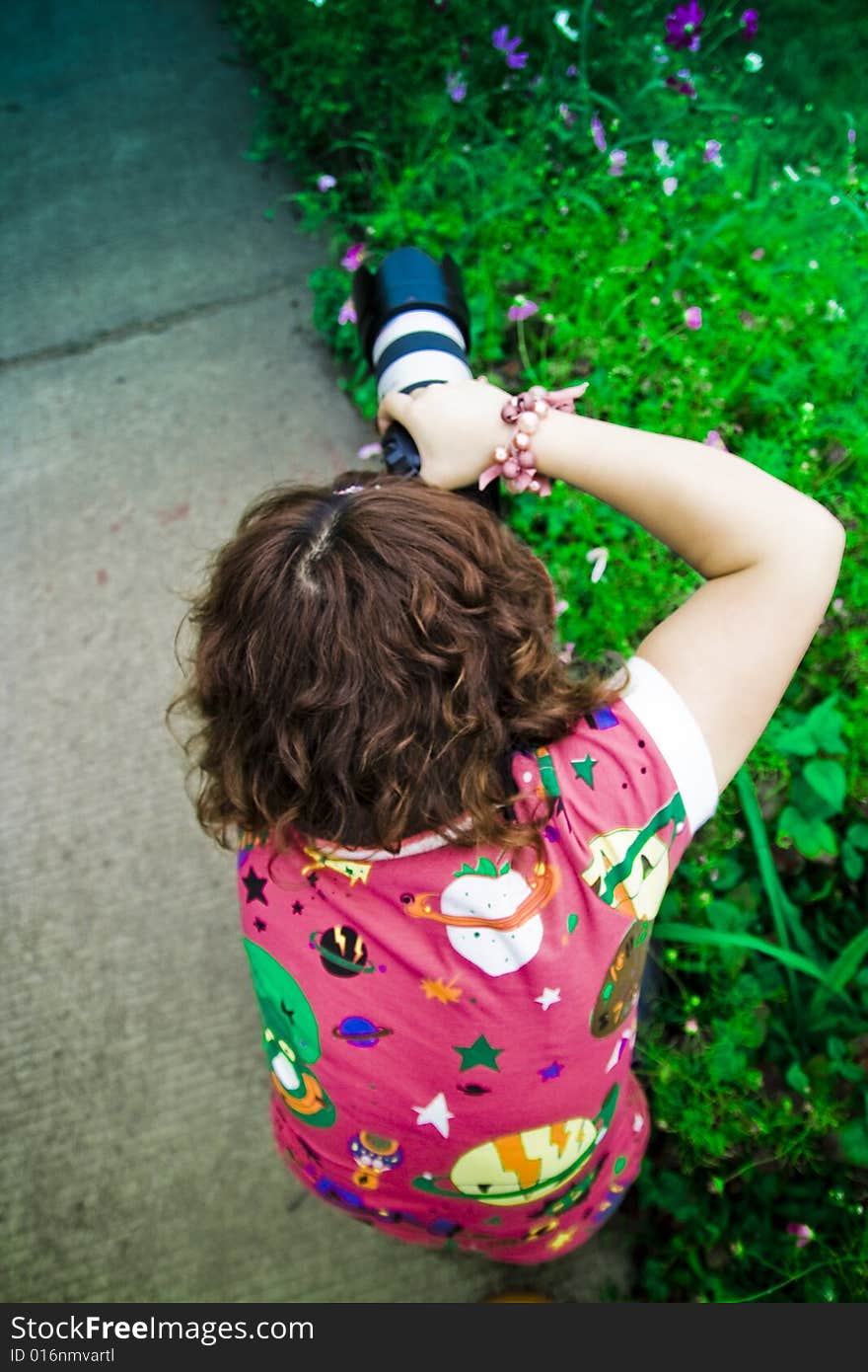 A girl is holding a camera. A girl is holding a camera