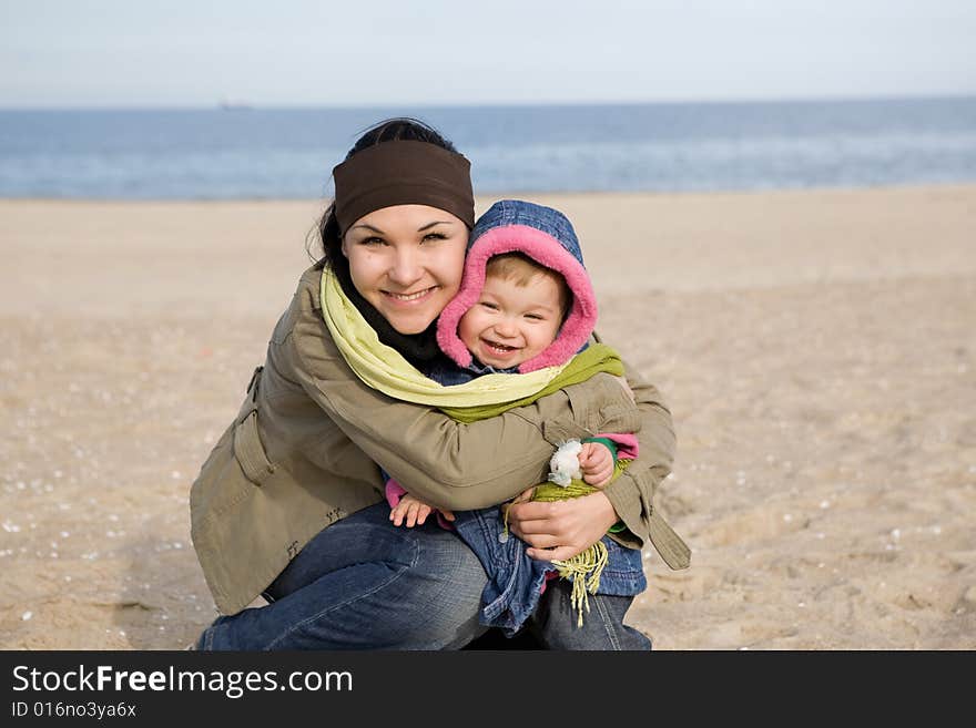 Mother and daughter together on the beach. Mother and daughter together on the beach