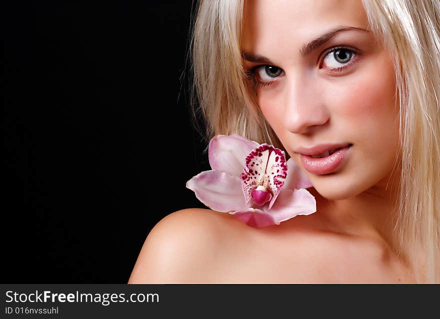 Face of beautiful young woman with delicate orchid. Face of beautiful young woman with delicate orchid