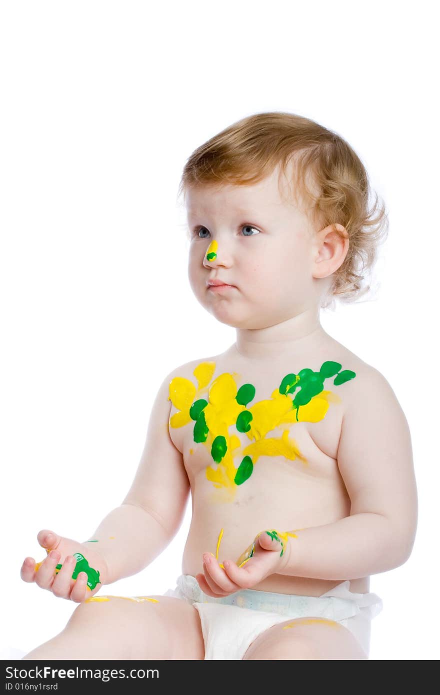 Little artist with many of paint spots on her body and face