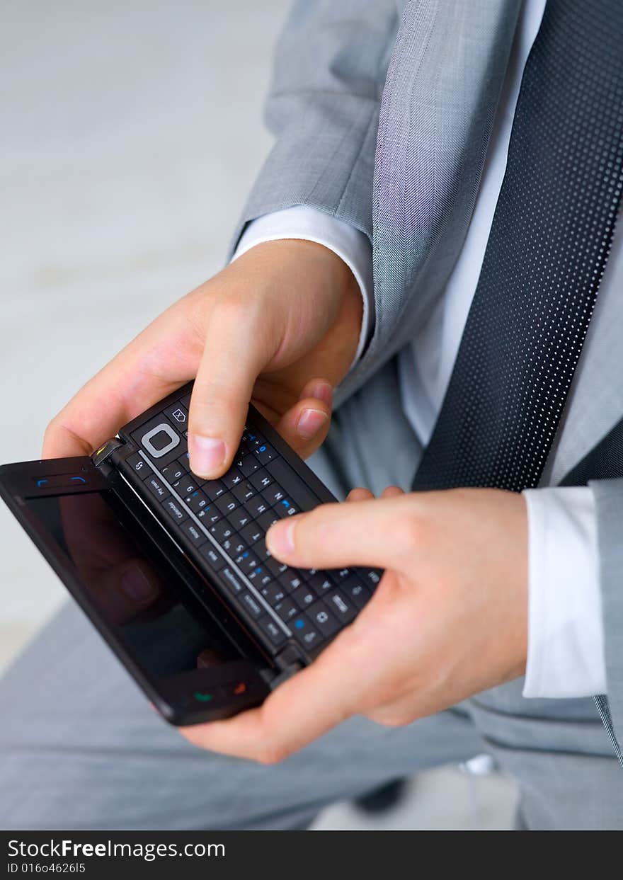 Close up of middle aged business man using cell phone. Close up of middle aged business man using cell phone