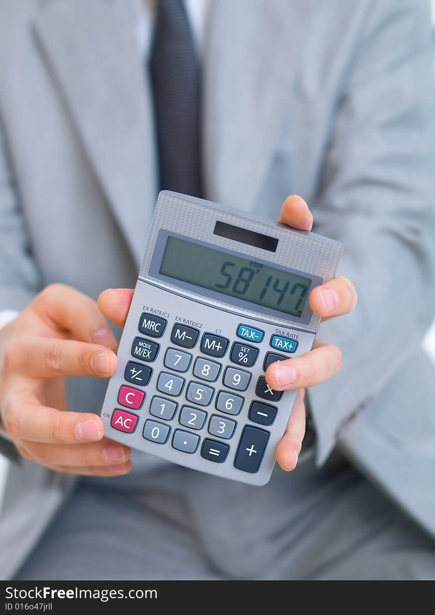 Close up of middle aged business man using calculator. Close up of middle aged business man using calculator