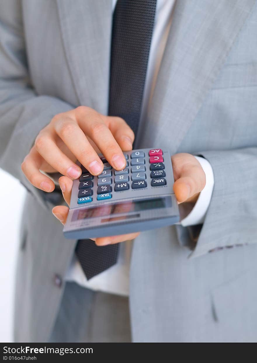 Close up of middle aged business man using calculator. Close up of middle aged business man using calculator