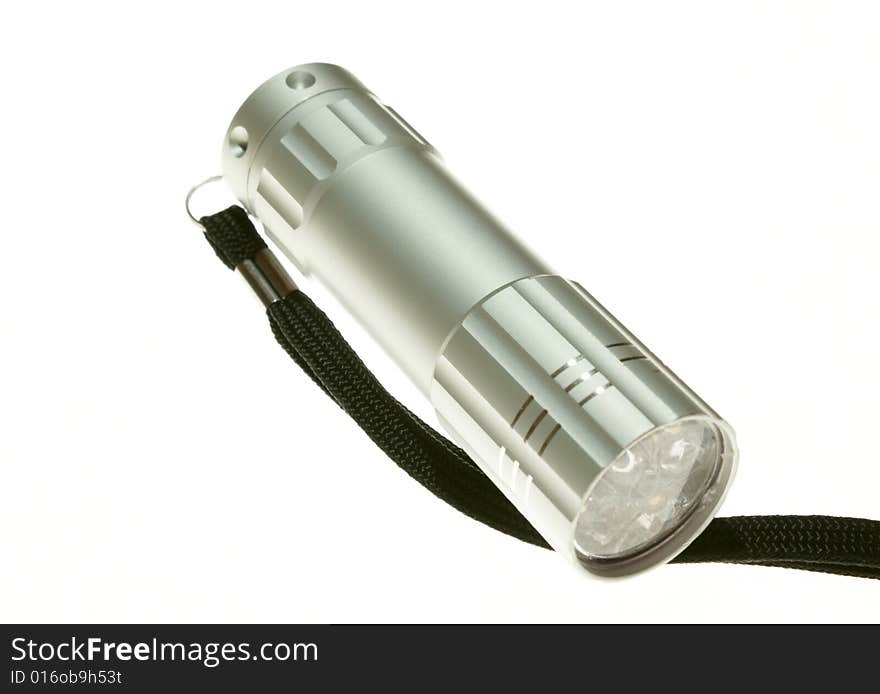 An electric flashlight on a white background. An electric flashlight on a white background