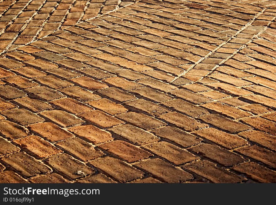 Sunsetting on old brick sidewalk casting deep shadows. Sunsetting on old brick sidewalk casting deep shadows