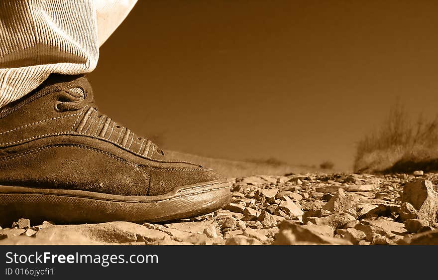 Close up of a man's shoe on a stone walk path. Close up of a man's shoe on a stone walk path