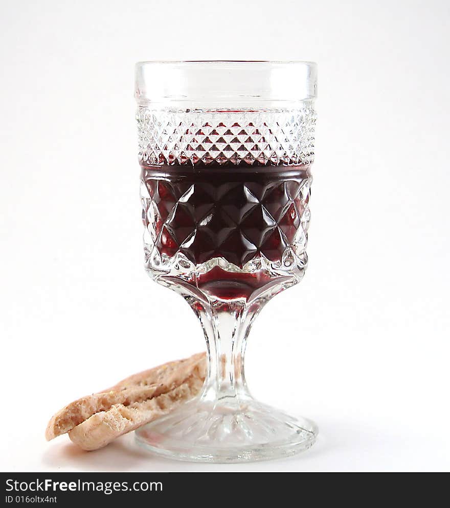 Glass of red wine with a piece of bread isolated on a white background. Glass of red wine with a piece of bread isolated on a white background