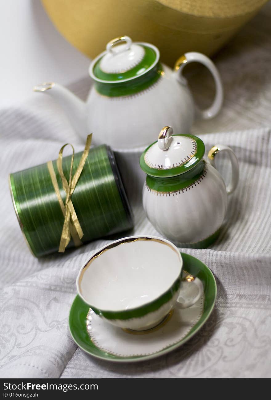 White with green tea service and gift box on napkin