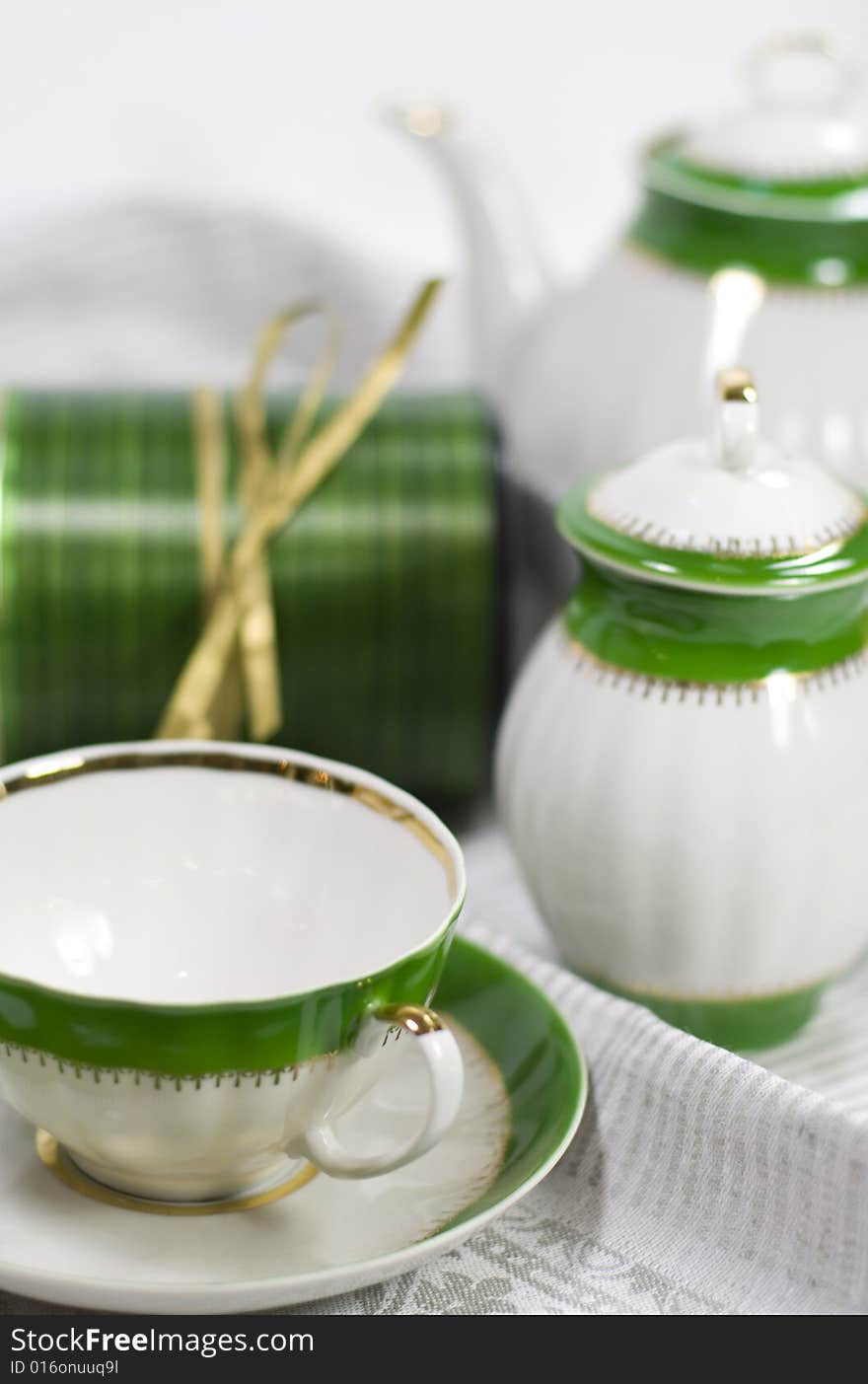 White with green tea service and gift box on napkin