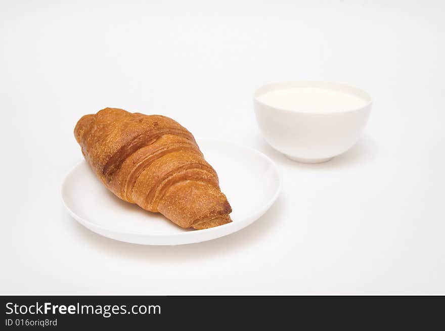 Croissant and milk isolated on white. Croissant and milk isolated on white