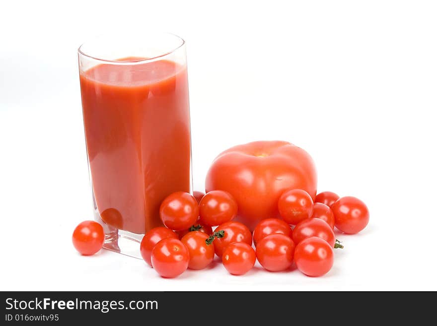 Tomatoes and juice on a white background