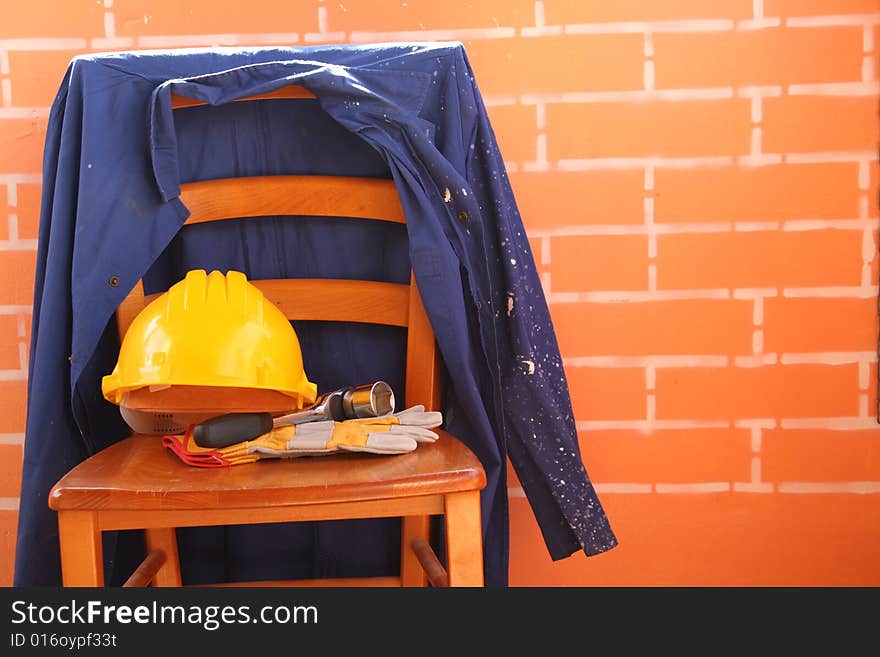 A chair is working clothes and tools. A chair is working clothes and tools