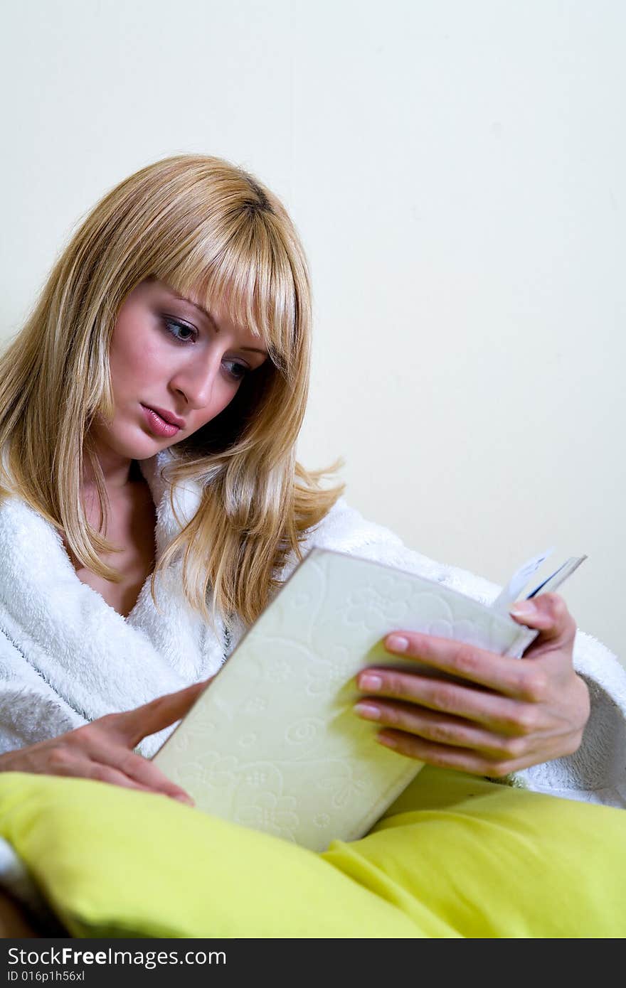 Blond model is reading a book. Blond model is reading a book