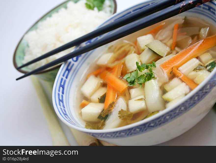 A chinese soup with coriander and some rice. A chinese soup with coriander and some rice