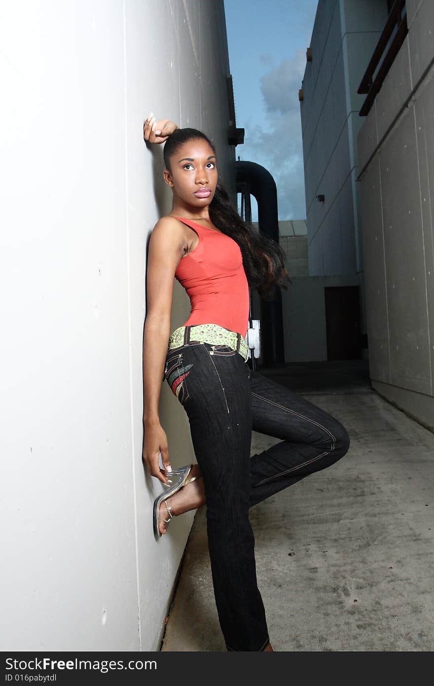 Young female against a concrete wall. Young female against a concrete wall