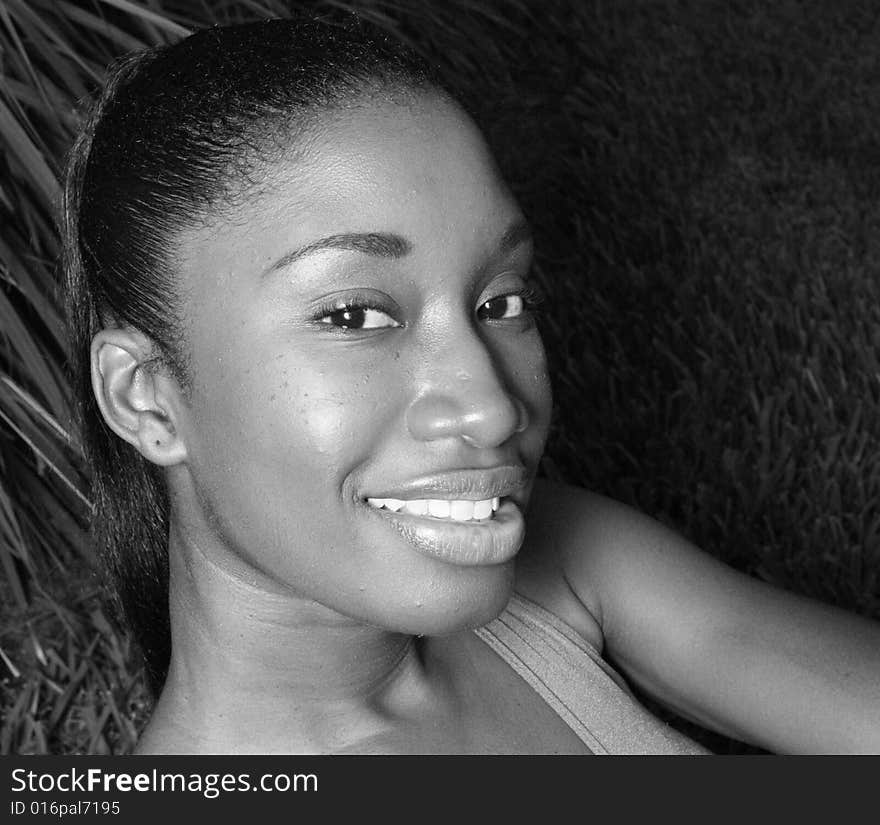 Headshot of a beautiful young female smiling. shot in black and white. Headshot of a beautiful young female smiling. shot in black and white.