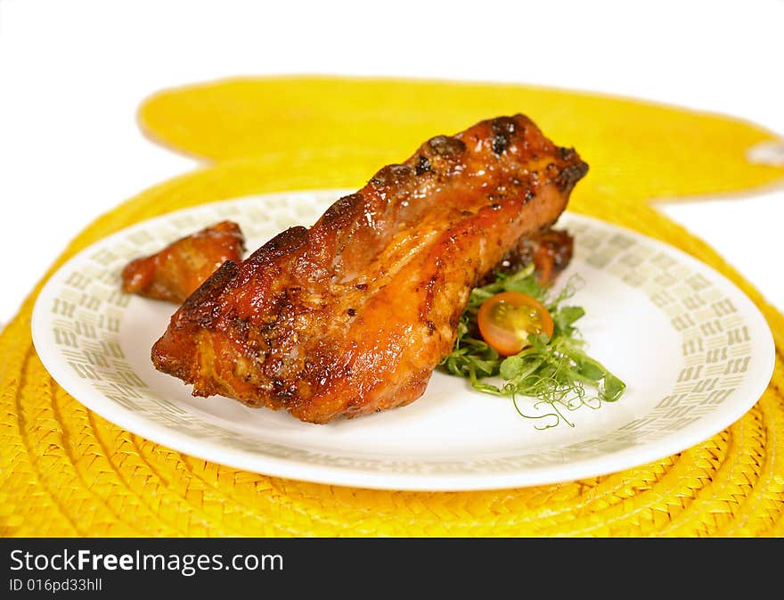 Honey glazed pork ribs served on salad