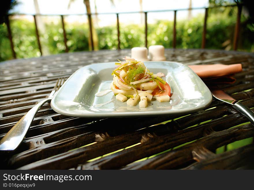 Octopus salad served as a starter in an outdoor restaurant