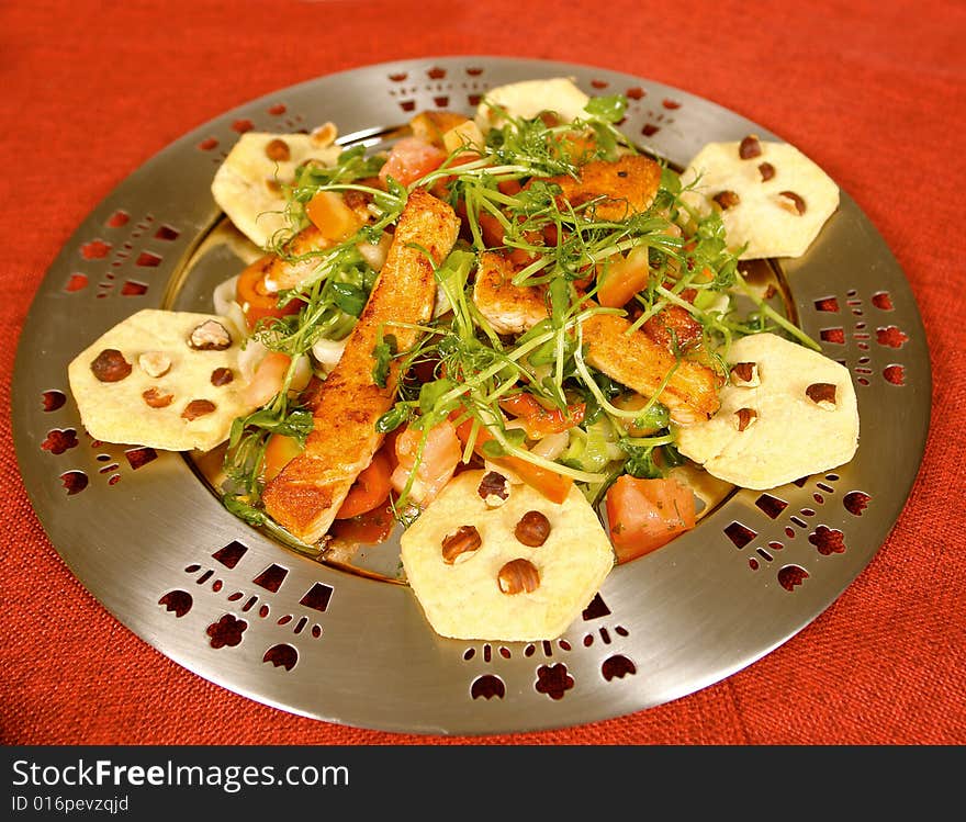 Trout fillets served with hazelnut cookies and salad