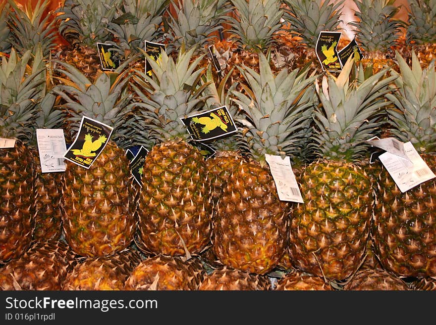 Alot of pineapples on stand in Market in Spain