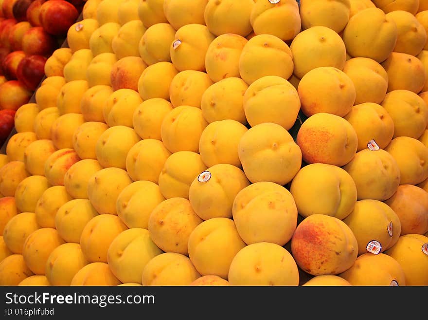 Alot of peaches  on stand in Market in Spain