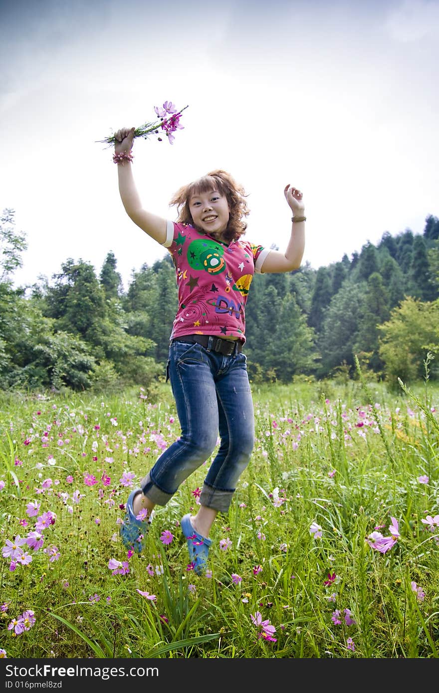 A girl jumpping and holding A bouquet of flowers. A girl jumpping and holding A bouquet of flowers