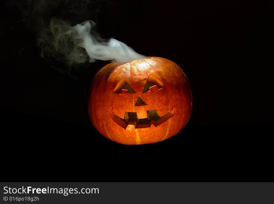 Halloween pumpkin with smoking crown of the head. Halloween pumpkin with smoking crown of the head