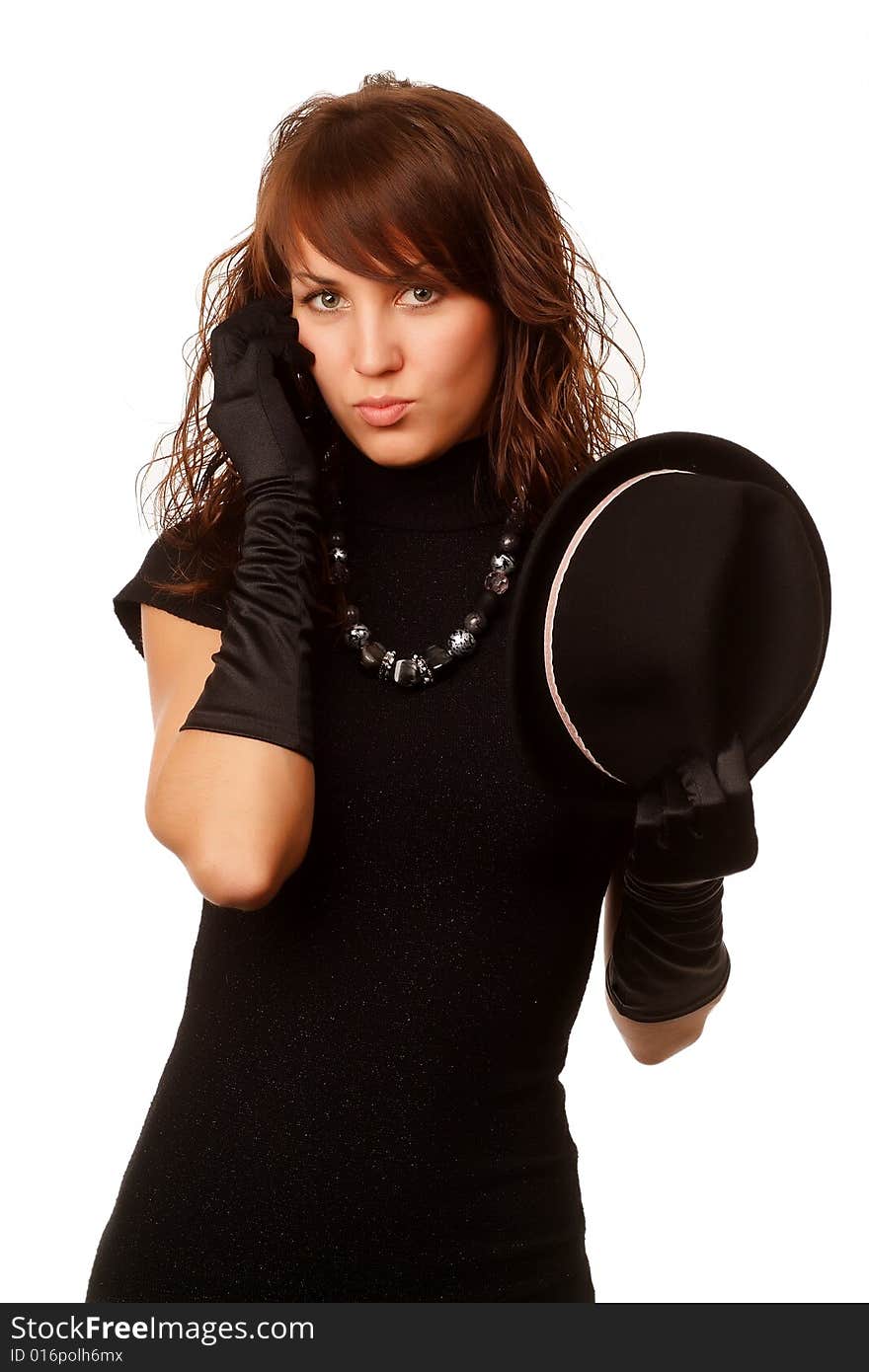 The girl in black clothes on a white background with a hat hat