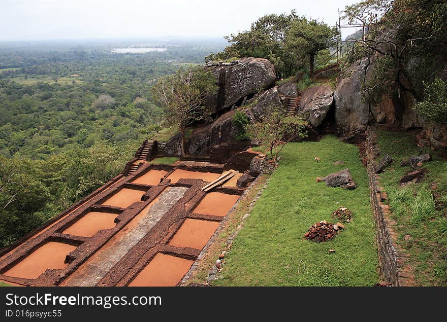 On top of a very high mountain in sri lanka you find old castle and temple ruins. On top of a very high mountain in sri lanka you find old castle and temple ruins