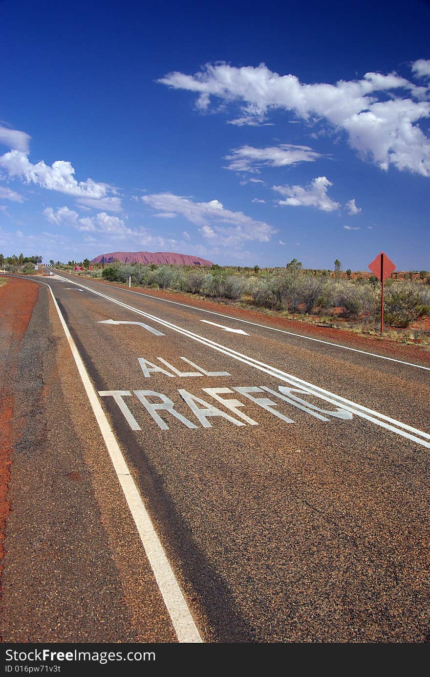 “All Traffic” to Uluru. Road markings directing the traffic to Australia’s famous monolith, Uluru (Ayers Rock). Uluru – Kata Tjuta National Park, Northern Territory, Australia. “All Traffic” to Uluru. Road markings directing the traffic to Australia’s famous monolith, Uluru (Ayers Rock). Uluru – Kata Tjuta National Park, Northern Territory, Australia.