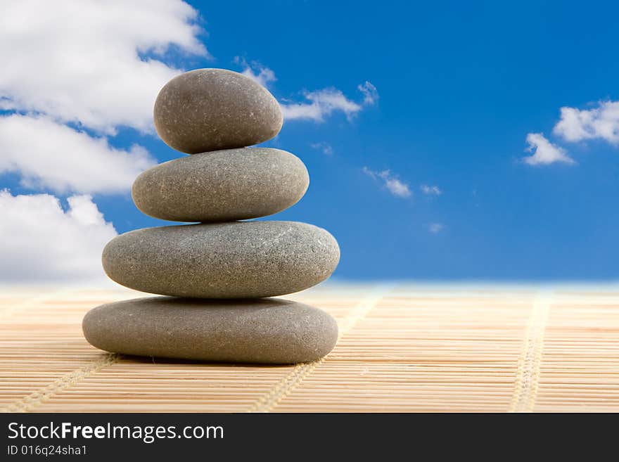 Balanced stones isolated on wooden background